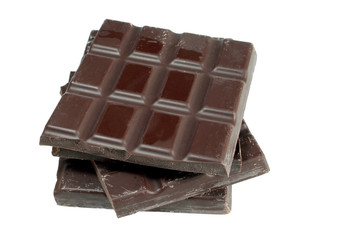 Pieces of dark chocolate isolated on white background
