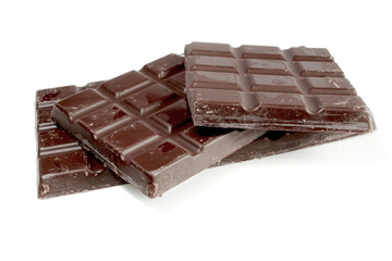 Pieces of dark chocolate isolated on white background
