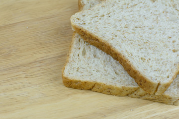 Bread whole wheat on wood background