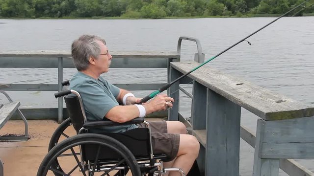 Handicapped fisherman in a wheelchair at a disability pier