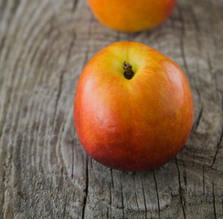 Ripe nectarines on rustic wooden background. Selective focus, cl