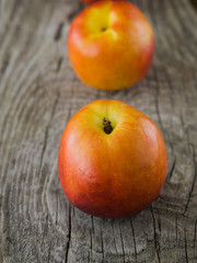 Nectarines on rough rustic wooden background close up selective