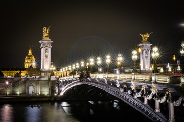 Fototapeta na wymiar Pont Alexandre III Bridge illuminated at night in Paris, France