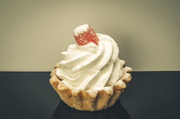 cupcake on a black table/cupcake on a black table with a white background