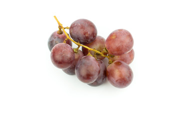 Ripe red grape with leaves isolated on white