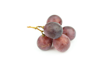 Ripe red grape with leaves isolated on white