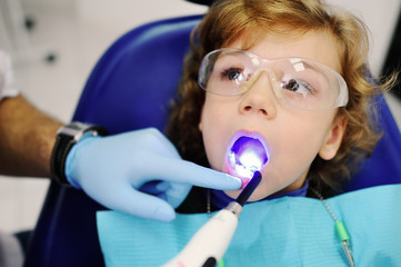 pediatric dentist man makes dental fillings baby boy
