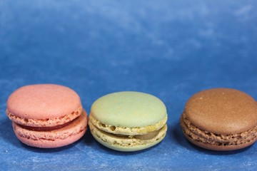 Macarons or macaroons on blue background
