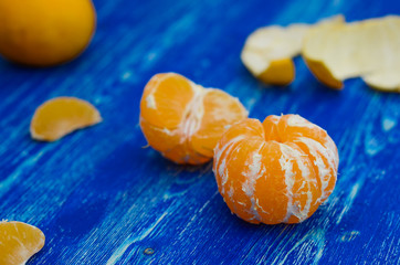 Tangerines on a blue wooden board, picture with space for text or logo