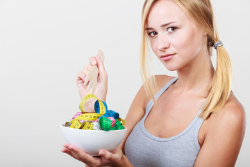 Diet. Girl with colorful measuring tapes in bowl