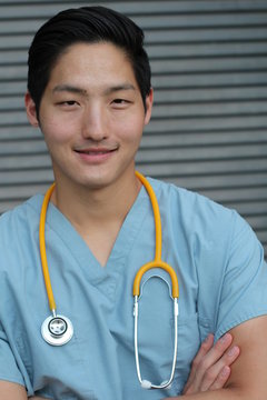 Asian nurse with his arms crossed 