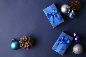 Blue present boxes with christmas decoration on blue background