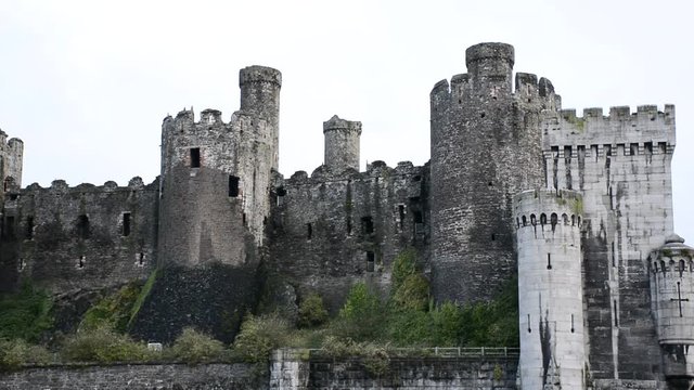 Conwy Castle south side showing stormy weather, sand bank, and river Conwy, medieval castle in Britain, Europe. close shot of towers/ turret.