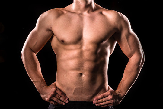 bodybuilder upper body below the neck isolated with black background