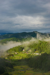 Dramatic landscape of Japanese high mountain village on foggy morning