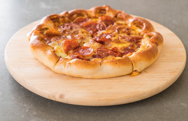 Homemade Pepperoni Pizza on wood plate