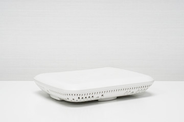 isolated white access point on table in office