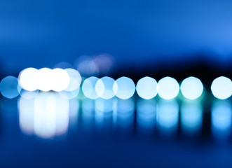 Night city lights bokeh with reflections background