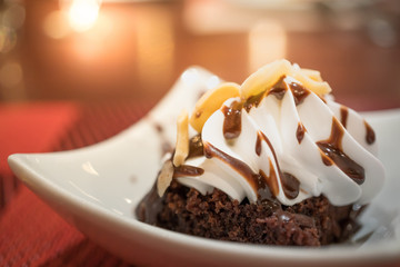 Decorated chocolate brownies with sliced almond and vanilla ice