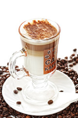 Cup of latte coffee on beans