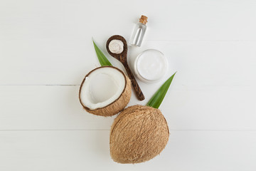 Fototapeta na wymiar Homemade coconut products on white wooden table background. Oil,