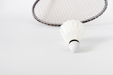 the white Badminton shuttlecock and racket on white background