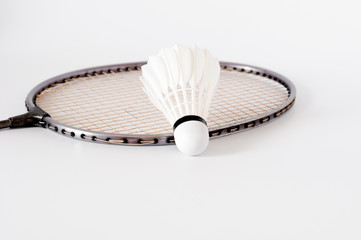 the white Badminton shuttlecock and racket on white background
