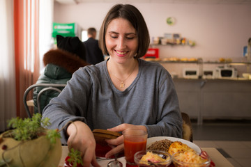 Happy and smiling girl in anticipation of dinner