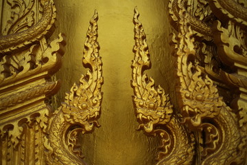 gold color wall of Wat Pak Nam Jolo in Chachoengsao at Thailand.
