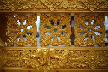 gold color wall of Wat Pak Nam Jolo in Chachoengsao at Thailand.