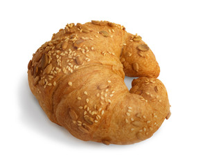 Croissant with sesame, pumpkin seeds isolated on a white background