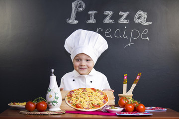 boy chef preparing a pizza