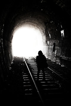 Woman Silhouette Standing at Bright Light and the End of an Old