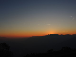 Fiery sunset from mountain pick in a clean evening. Fall season. Orobie alps.