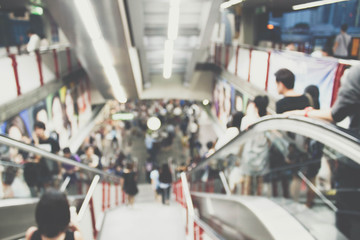 blurred photo of people on escalator..