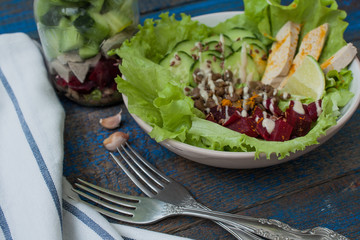Salad with beets, tofu, tahini, lime, lentils, cucumber, turmeric in a jar or on a plate.