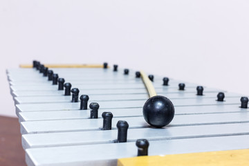 The metallophone and mallet on the white background
