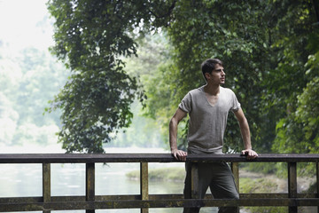 Fototapeta premium Young man standing on bridge