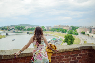 Fototapeta na wymiar A stylish girl looking at the river