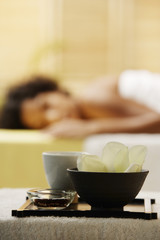 Obraz na płótnie Canvas closeup of spa treatment with woman in background