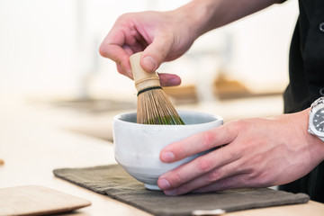 Matcha tea prepared with bamboo whisk
