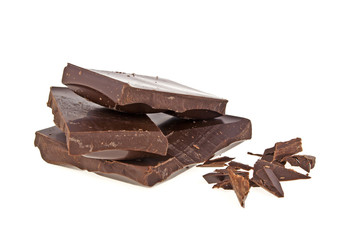 Heap of broken pieces of chocolate on white background
