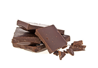 Heap of broken pieces of chocolate on white background