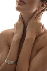 upper body of woman touching her neck