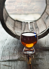 Glass of whiskey and a old barrel