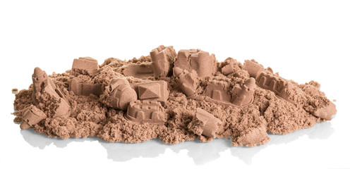 Battered sandcastles closeup isolated on white.