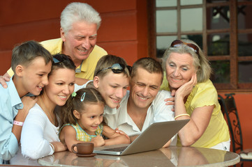 family sitting with laptop