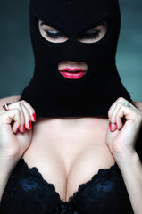 girl in bra and balaclava - black and white photo in studio of a psycho girl terrorist - obrazy, fototapety, plakaty