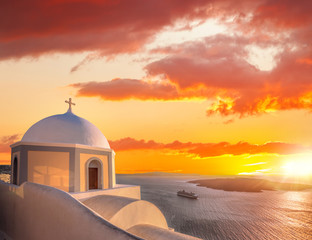Old Town of Thira on the island Santorini, white church against colorful sunset in Greece - obrazy, fototapety, plakaty
