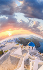 Old Town of Thira on the island Santorini, famous church against colorful sunset in Greece